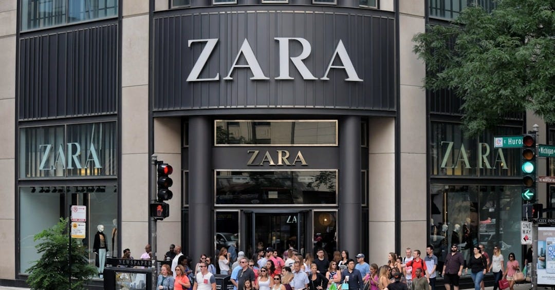 a group of people walking on the sidewalk