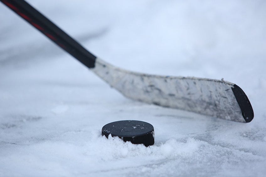 Hockey stick and puck on the ice