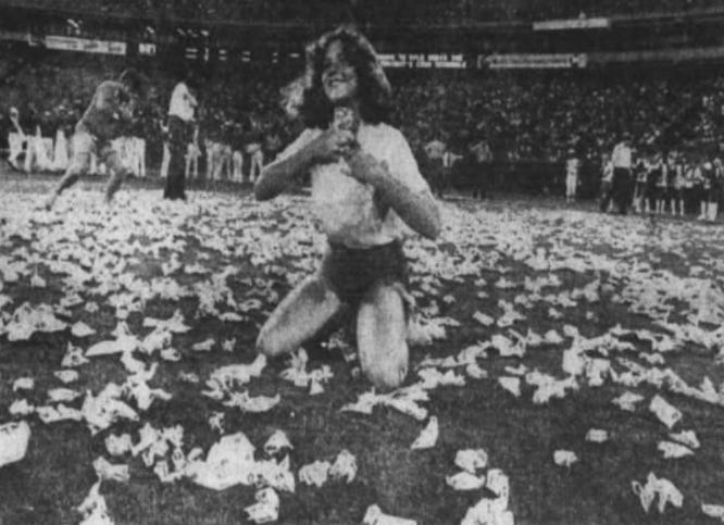 A contestant stuffs money in her shirt during the Braves' 1975 cash scramble. A contestant stuffs money in her shirt during the Braves' 1975 cash scramble.