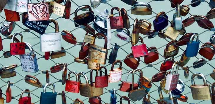 Photo of padlocks of different shapes, sizes and colours.