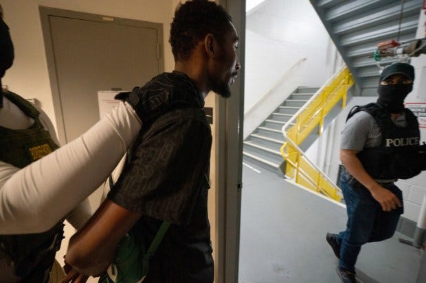 Federal law enforcement officers take an immigrant into custody in the Jacob K. Javits Federal Building in Manhattan on Thursday.