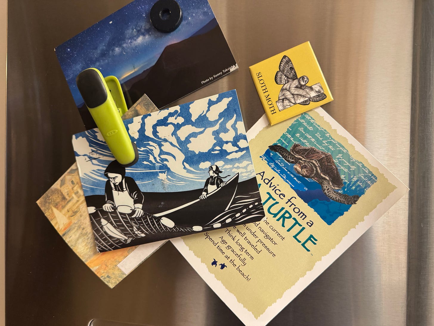 assorted postcards with magnets on fridge