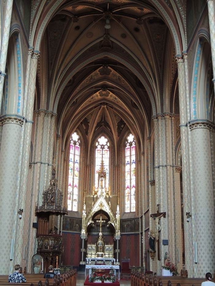 A low angle view of a church

AI-generated content may be incorrect.