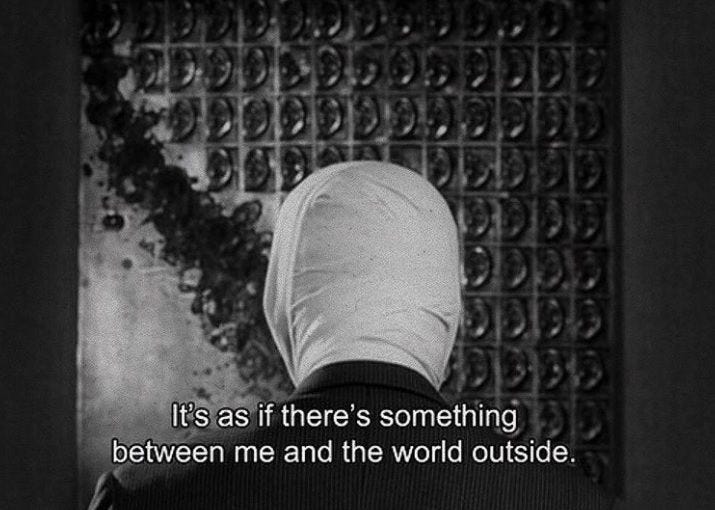 This may contain: a person standing in front of a metal grate with the words it's as if there is something between me and the world outside