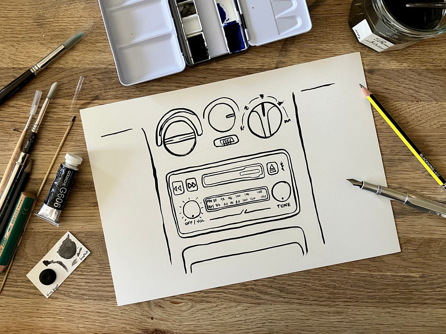 Painted image of car radio cassette player sits atop a wooden table Painted image of car radio cassette player sits atop a wooden table