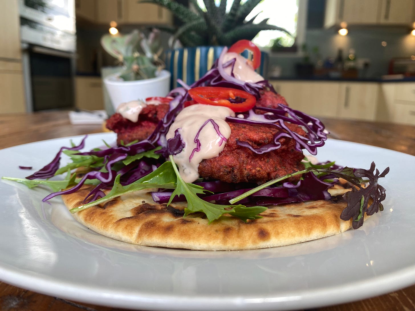 Plate topped with flatbread, falafel and salad