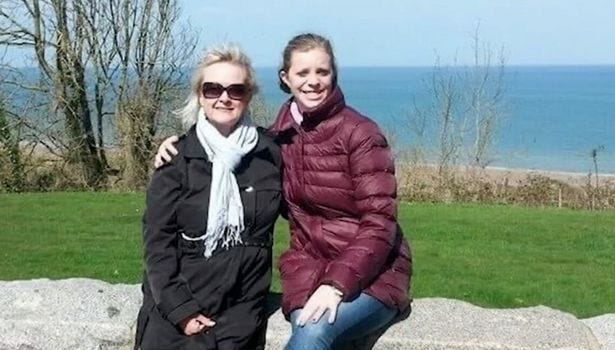 Patricia Dugas and her daughter Tina Dugas posing for a photo together at the seaside Patricia Dugas and her daughter Tina Dugas posing for a photo together at the seaside