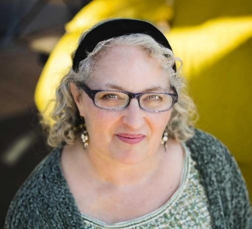 A person with glasses and a black headband A person with glasses and a black headband