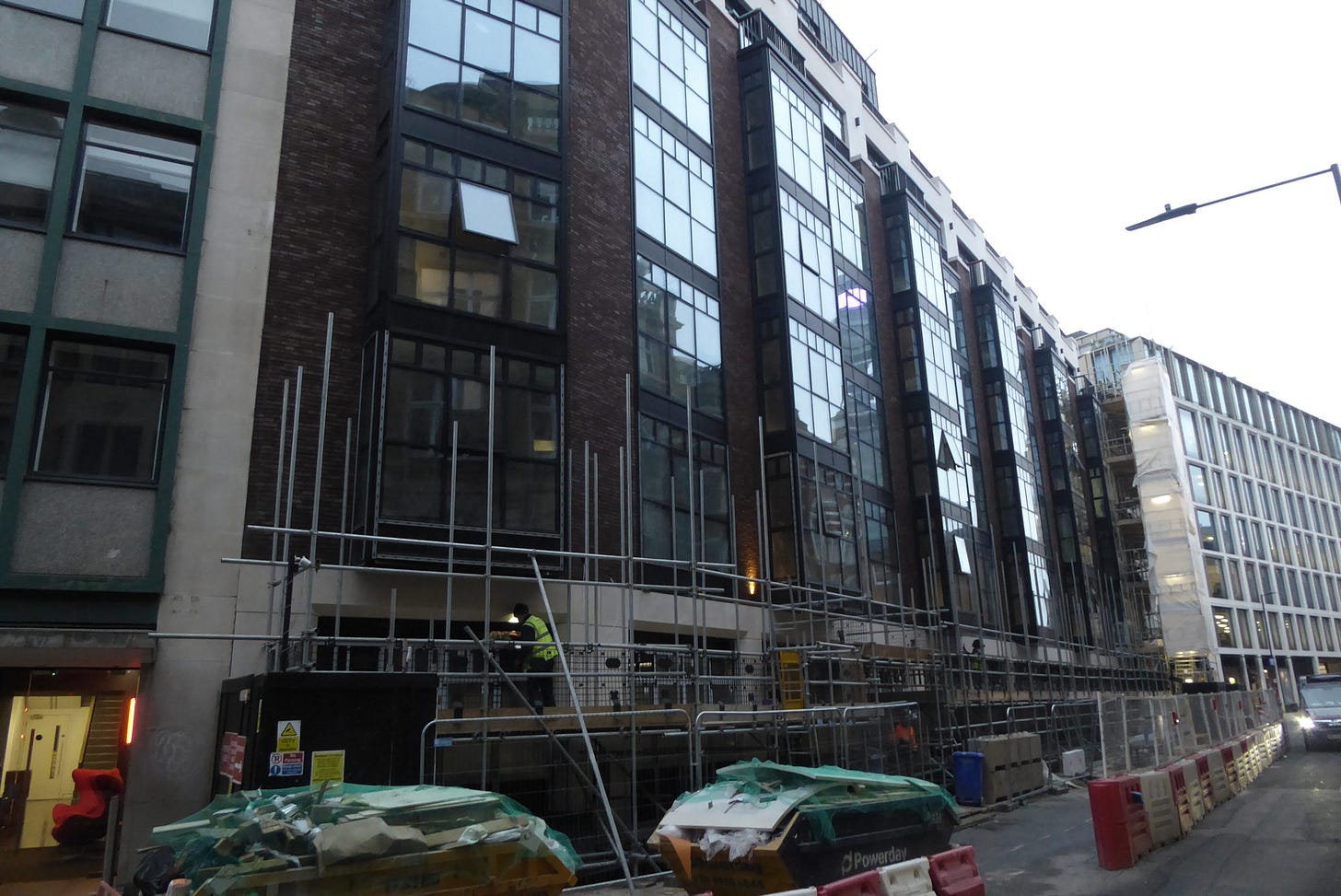 View from the street of The Newman Hotel with scaffolding around it.