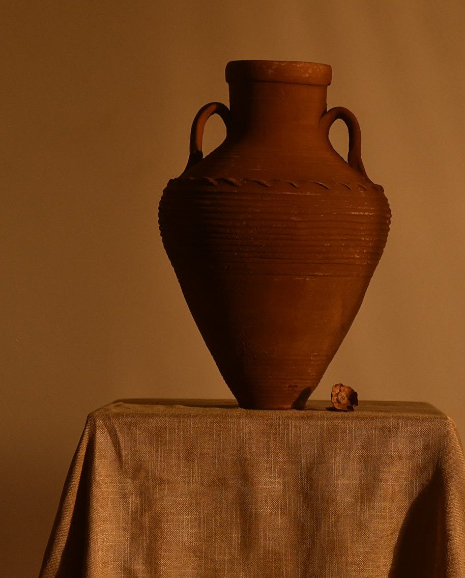 brown ceramic vase on white table cloth brown ceramic vase on white table cloth