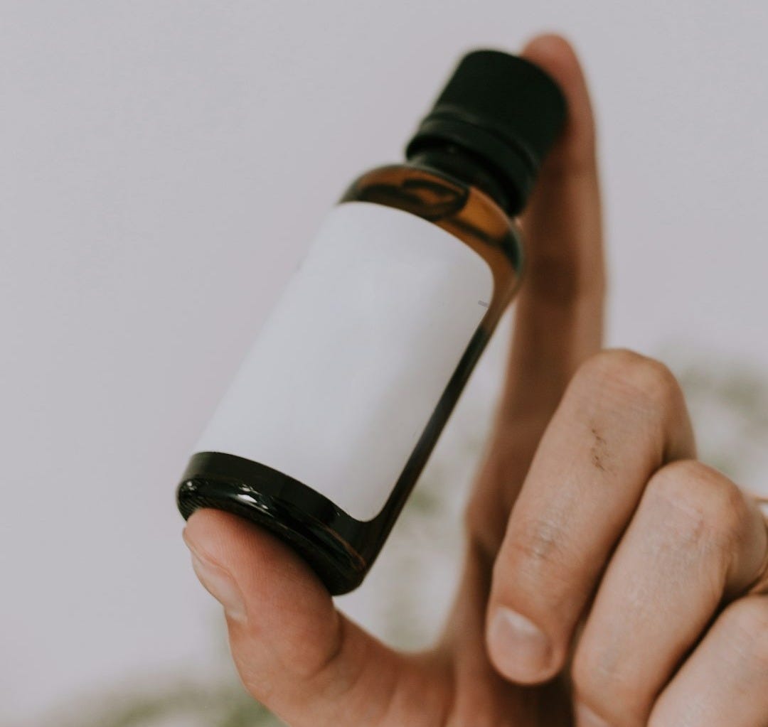 white and brown glass bottle
