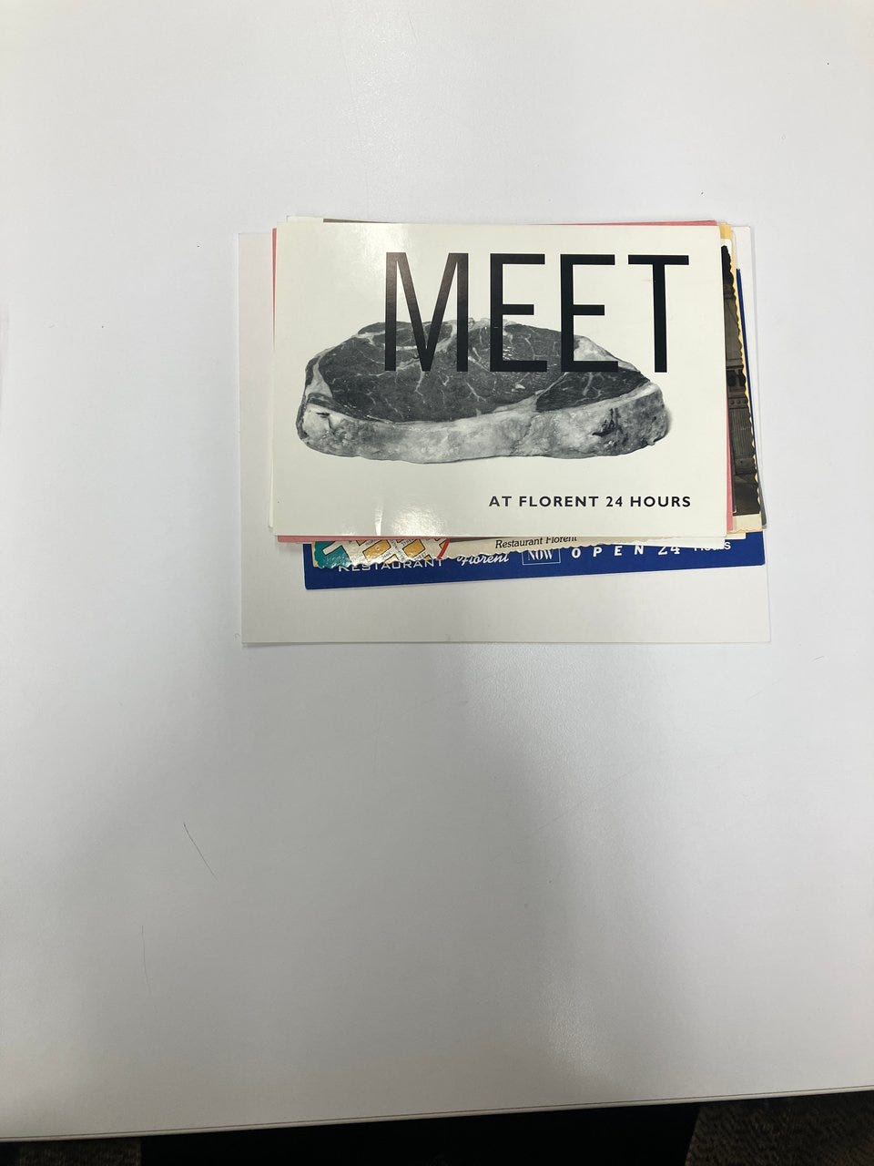 A photo of meat with the word MEET in large letters on top, then smaller letters "at Florent 24 hours"
