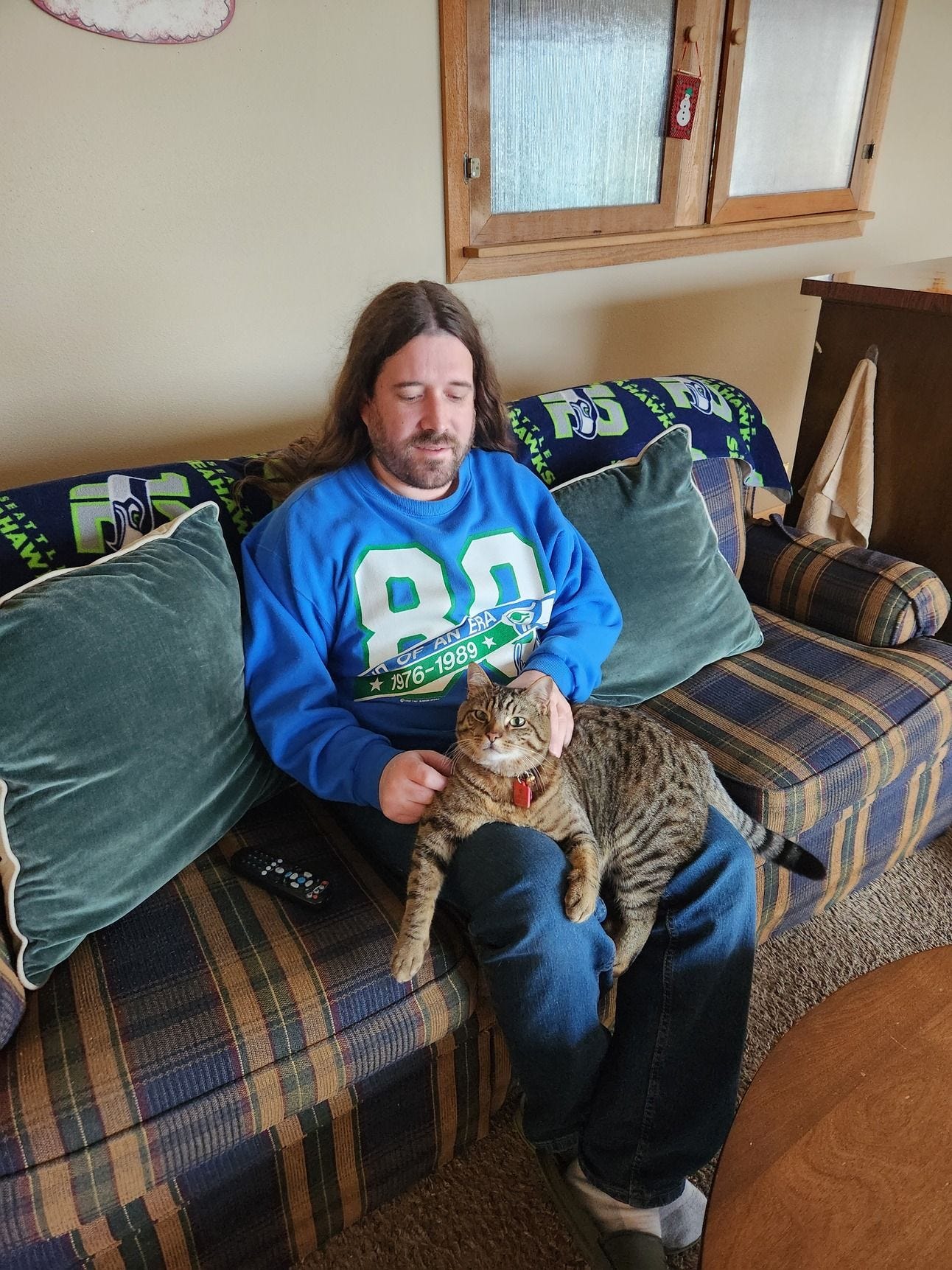 cat sitting on a guy's lap cat sitting on a guy's lap