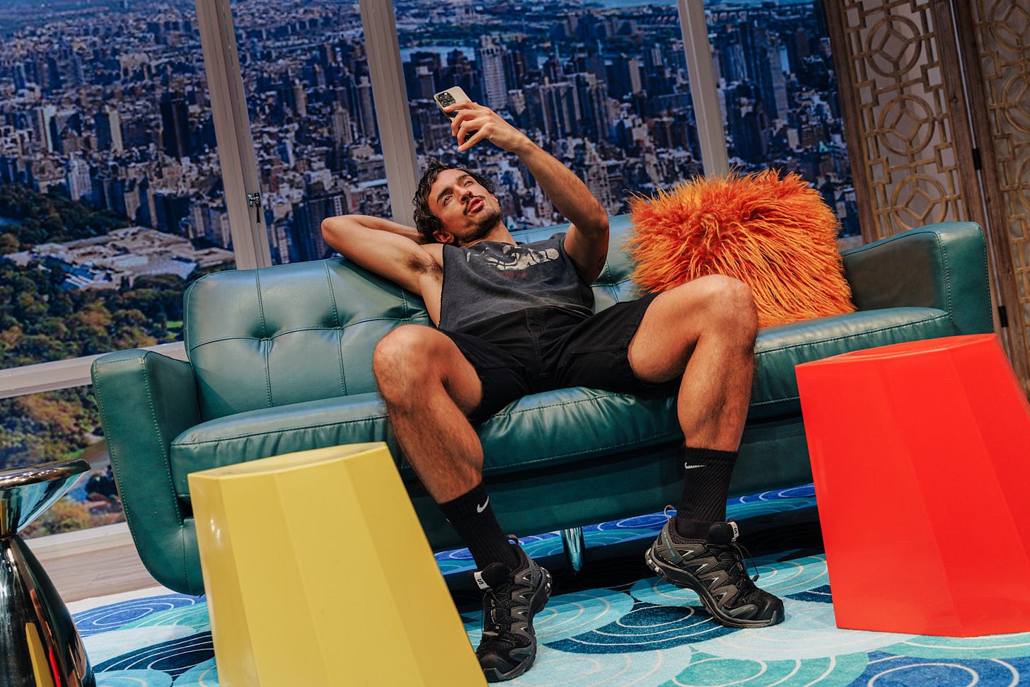 A muscular gay man records a social media post while flexing his muscles and spreading his legs A muscular gay man records a social media post while flexing his muscles and spreading his legs