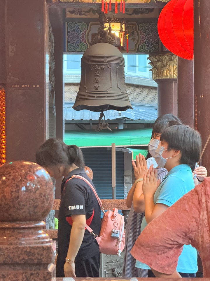 People praying in a temple; a priest praying in a Cathedral. Taiwan.