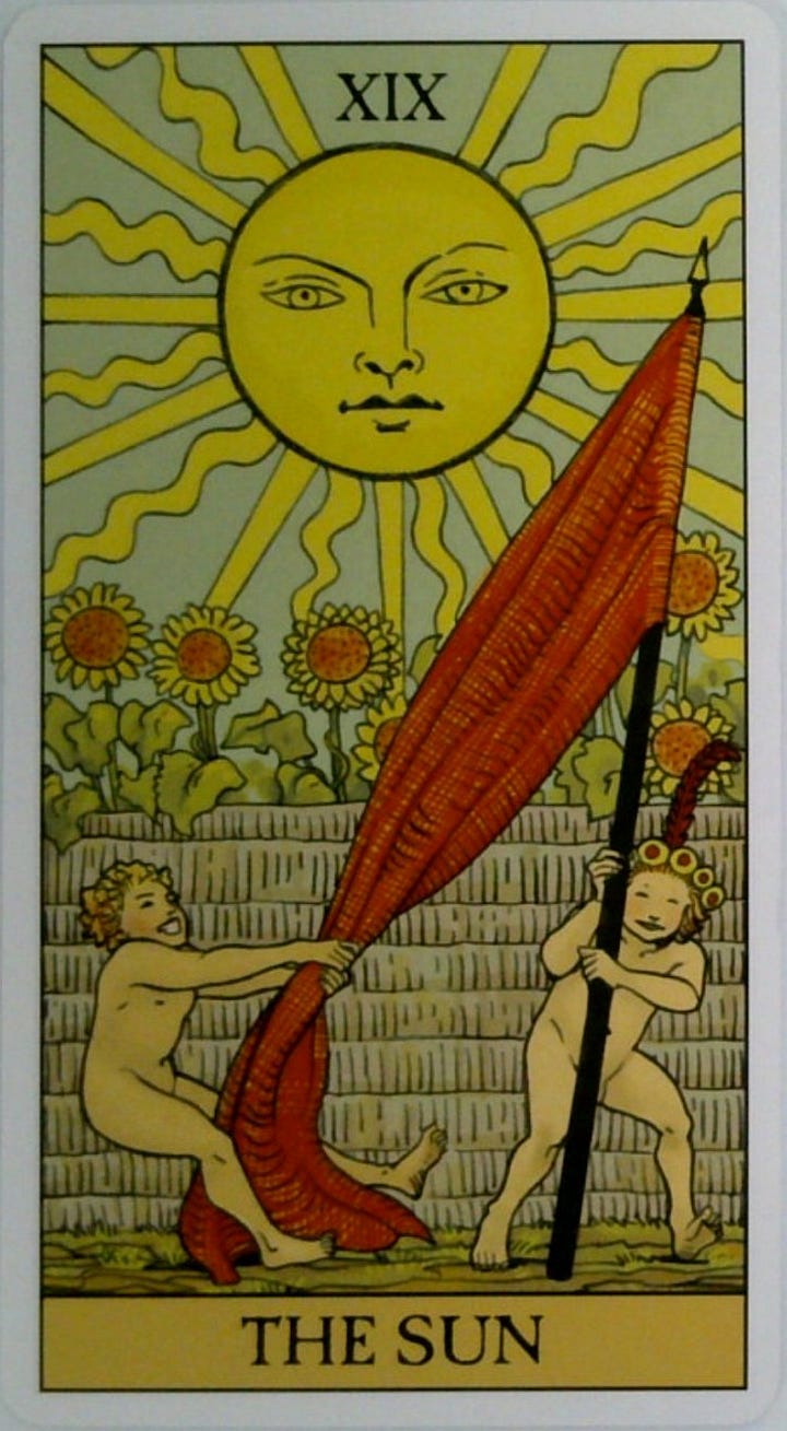 The Sun tarot card and the Clear Limiting Beliefs oracle card.