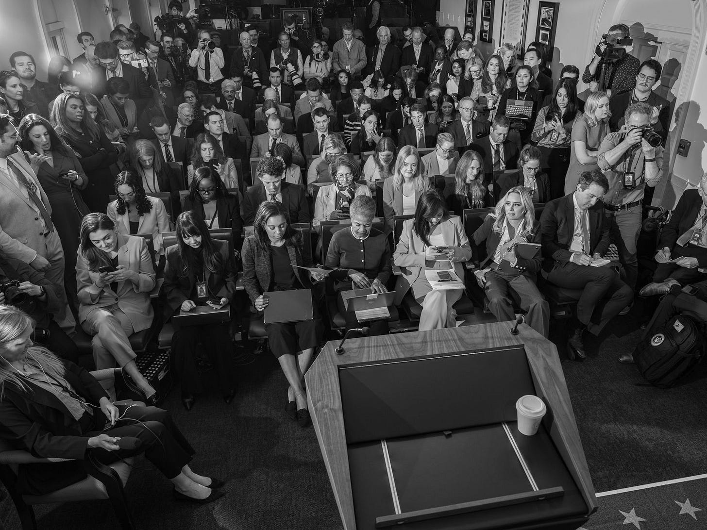 Journalists wait for a news conference to begin at the White House. Journalists wait for a news conference to begin at the White House.