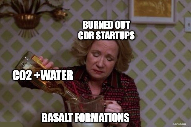 That '70s Show still of Kitty pouring liquor into a glass. She is labelled "Burned out CDR startups", the bottle "CO2 + water" and the glass "Basalt formations".