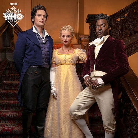 Pics 1 and 2 L-R: Jonathan Groff, Millie Gibson and Ncuti Gatwa on set for the upcoming series of Doctor Who. They are wearing regency-style clothing and standing together in the stairwell of an old manor. Pics 3-5 are additional pics of Gibson in a garden wearing a gold-coloured regency style dress with elbow-length white gloves.