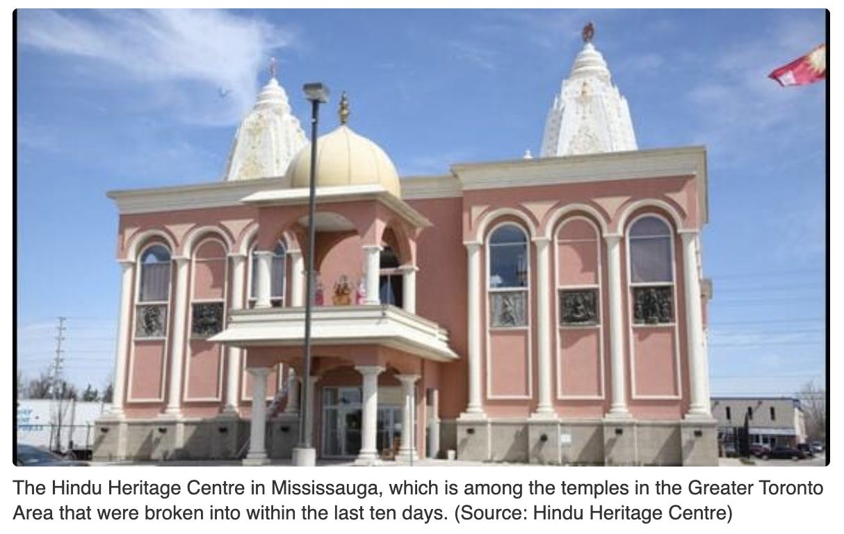 Photo shows a large rectangular building set on grey concrete foundations, painted a pinky peach color with white pillars and domes. The three domes rising from the roof are sculpted in traditional styles, two in rising geometric carving styles and one in smooth rounded style. There are six sculpted reliefs visible on the front of the building of Hindu deities placed between the white pillars that are built into the walls. The sculpted reliefs look to be unpainted and either dark grey/brown or light grey. It’s not clear if they are either stone or metal sculptures.The entrance way is in the center and has a roof that is supported by four white pillars. That entrance way extends forward and also has a second floor above which acts as a open balcony. The balcony is covered with one of the three domes that is supported by four white pillars. Three Hindu deities dressed in pink and yellow are displayed on the open balcony. They deities look to be made of marble. Caption below the picture reads in black text on a white background: “The Hindu Heritage Centre in Mississauga, which is among the temples in the Greater Toronto Area that were broken into within the last ten days. (Source: Hindu Heritage Centre)”