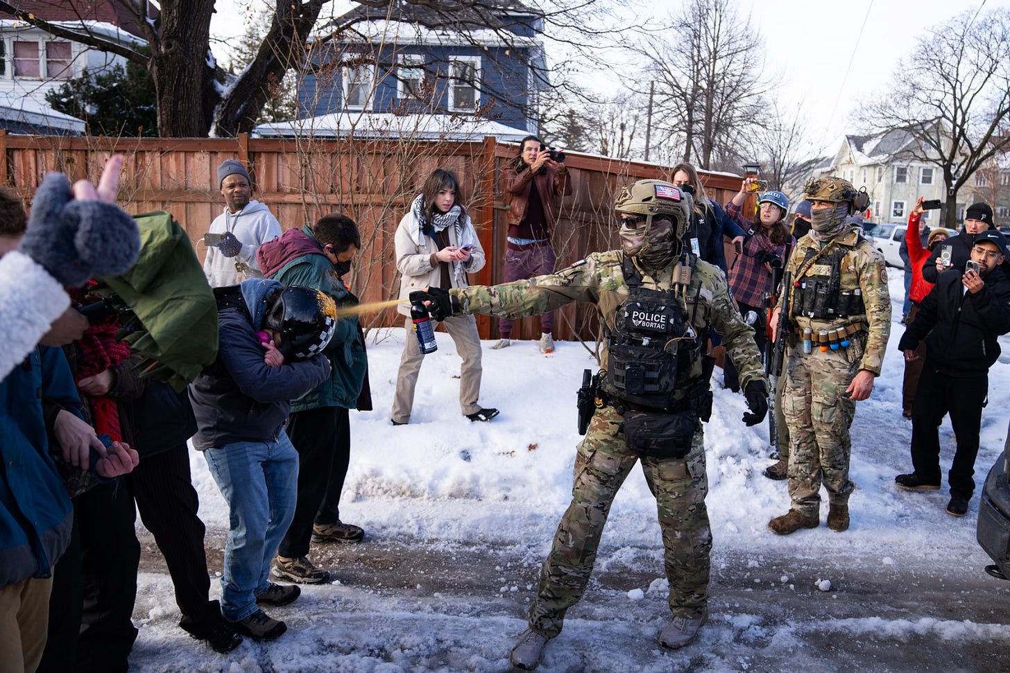 MINNEAPOLIS, MN. - JANUARY 2026: A Border Patrol Tactical Unit agent sprays pepper spray into the face of a protestor attempting to block an immigration officer vehicle from leaving the scene where a woman was shot and killed by a federal agent earlier, in Minneapolis, Minn. on Wednesday, January 7, 2026. The Department of Homeland Security confirmed that a woman was shot and killed by an Immigration and Customs Enforcement (ICE) agent during a confrontation between federal agents and protesters in south Minneapolis. (Photo by Alex Kormann/The Minnesota Star Tribune via Getty Images)