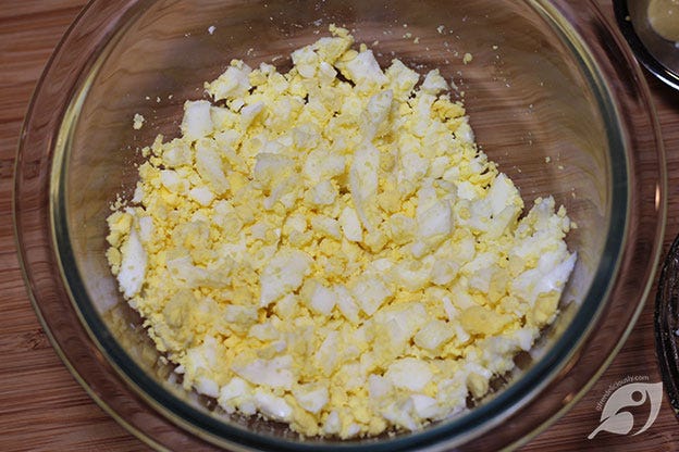 Egg salad step 1 - Add hard-boiled and peeled eggs to a medium-size mixing bowl and chop. Mix in the butter just until combined. Egg salad step 1 - Add hard-boiled and peeled eggs to a medium-size mixing bowl and chop. Mix in the butter just until combined.
