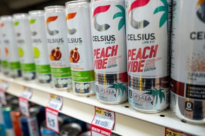 Celsius energy drink cans on a store shelf.