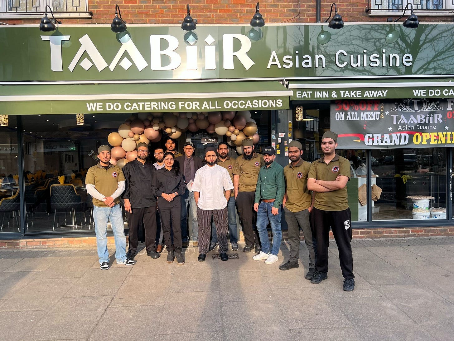 May be an image of ‎8 people and ‎text that says "‎TAABİİR Asian Cuisine WE DO CATERING FOR ALL OCCASIONS EAT INN & TAE AWAY 연매을 WE DO A ON ALL MENU ၉62 شقء TAABİİR Asian AsianCuisine Cuisine GRAND OPENI 海 ."០្រ‎"‎‎