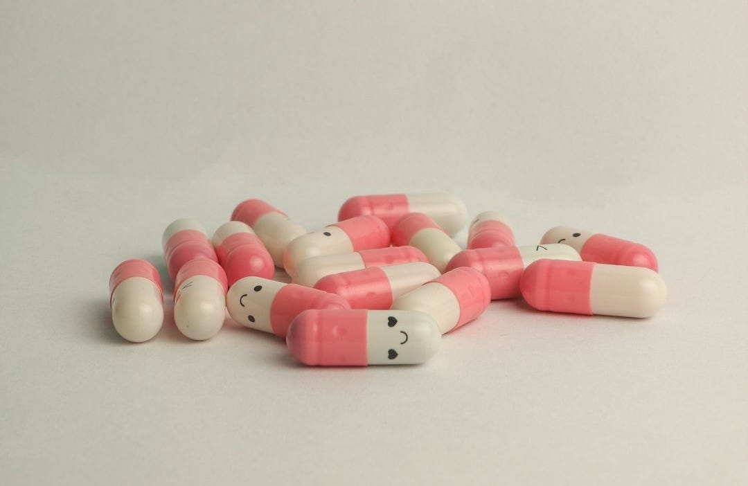 pink and white medication pill pink and white medication pill