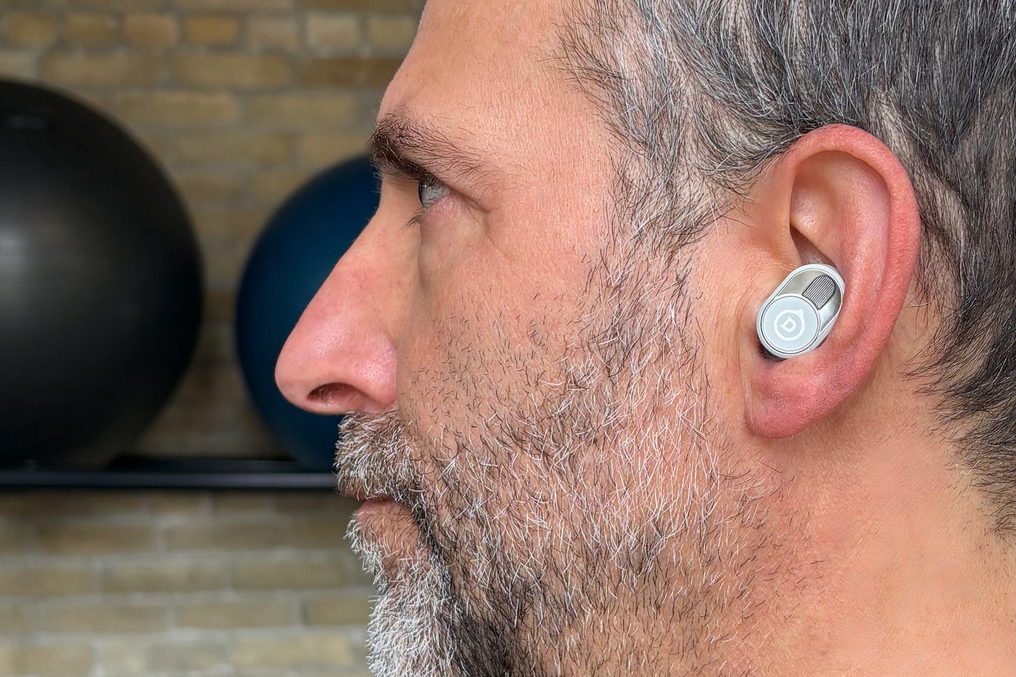 Simon Cohen wearing the Devialet Gemini II wireless earbuds