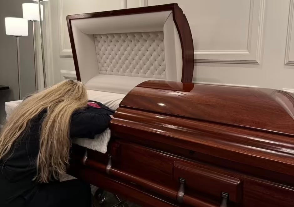 Erika Kirk beside Charlie’s body in the casket.