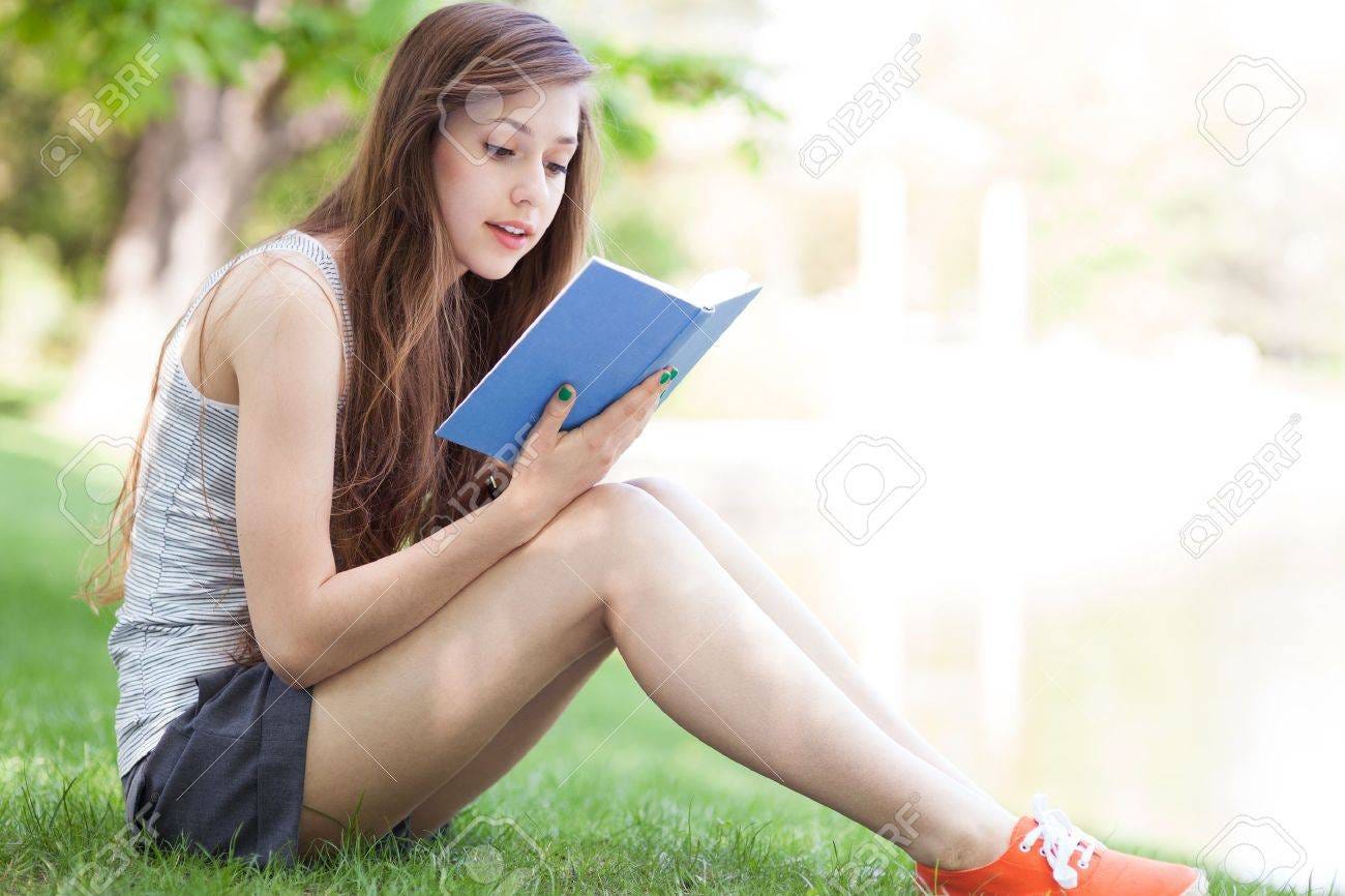 Young Woman Reading Book Outdoors Stock Photo, Picture And Royalty Free  Image. Image 13772591.