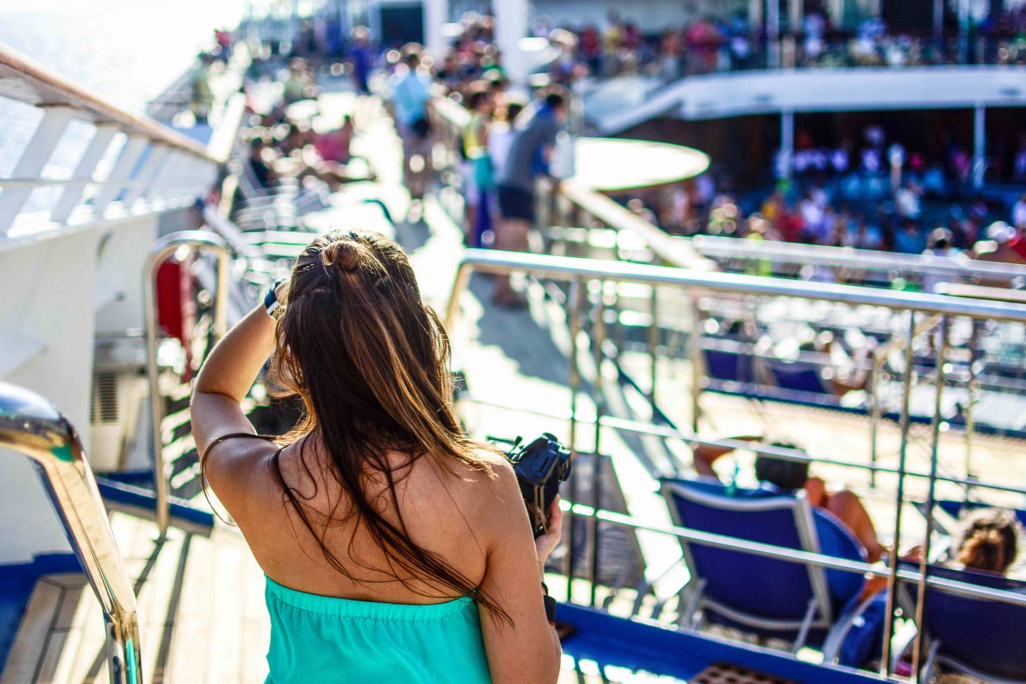 woman looking out at cruise ship from deck woman looking out at cruise ship from deck