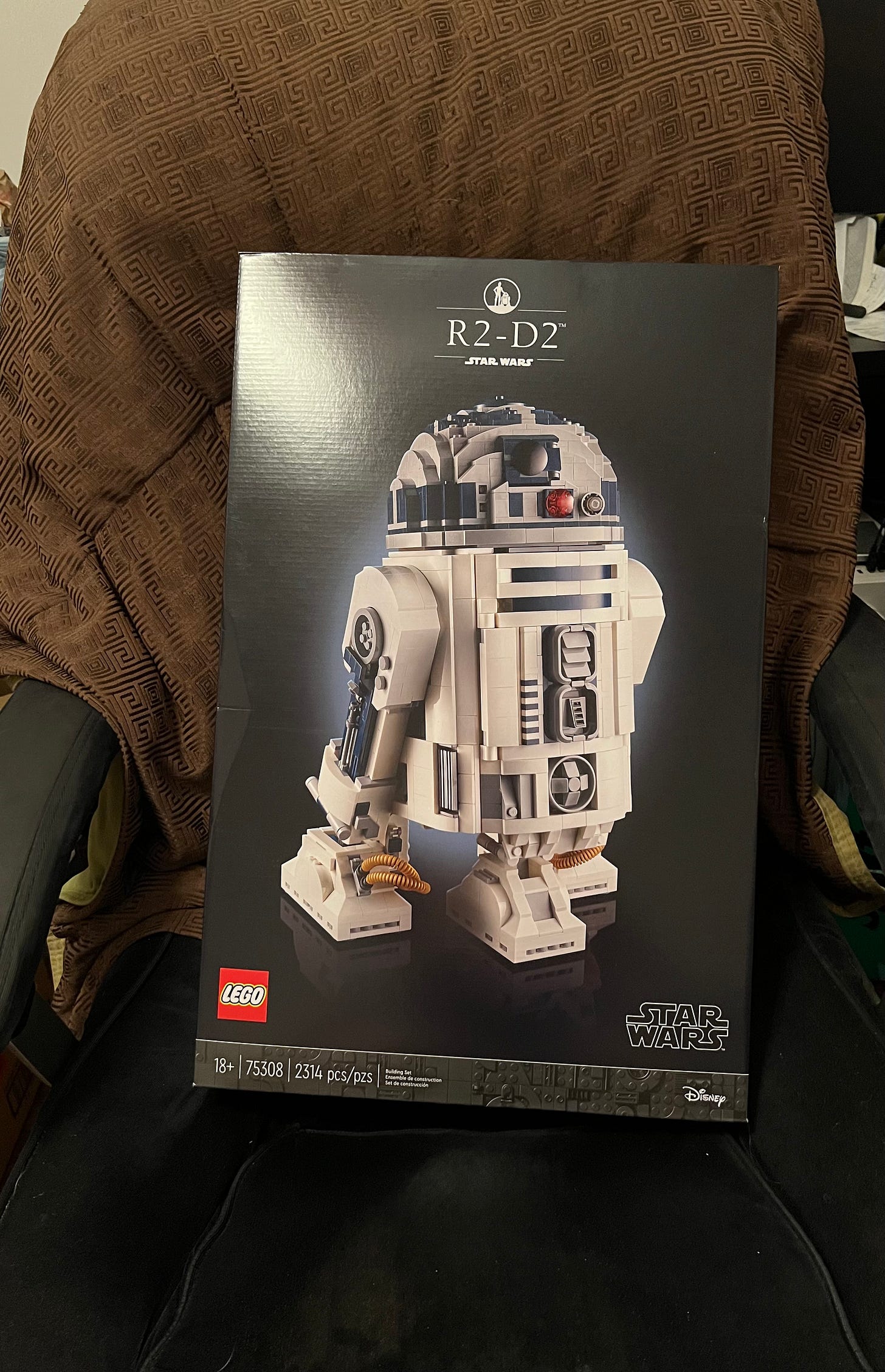 Photo of Lego R2-D2 kit sitting in my computer chair