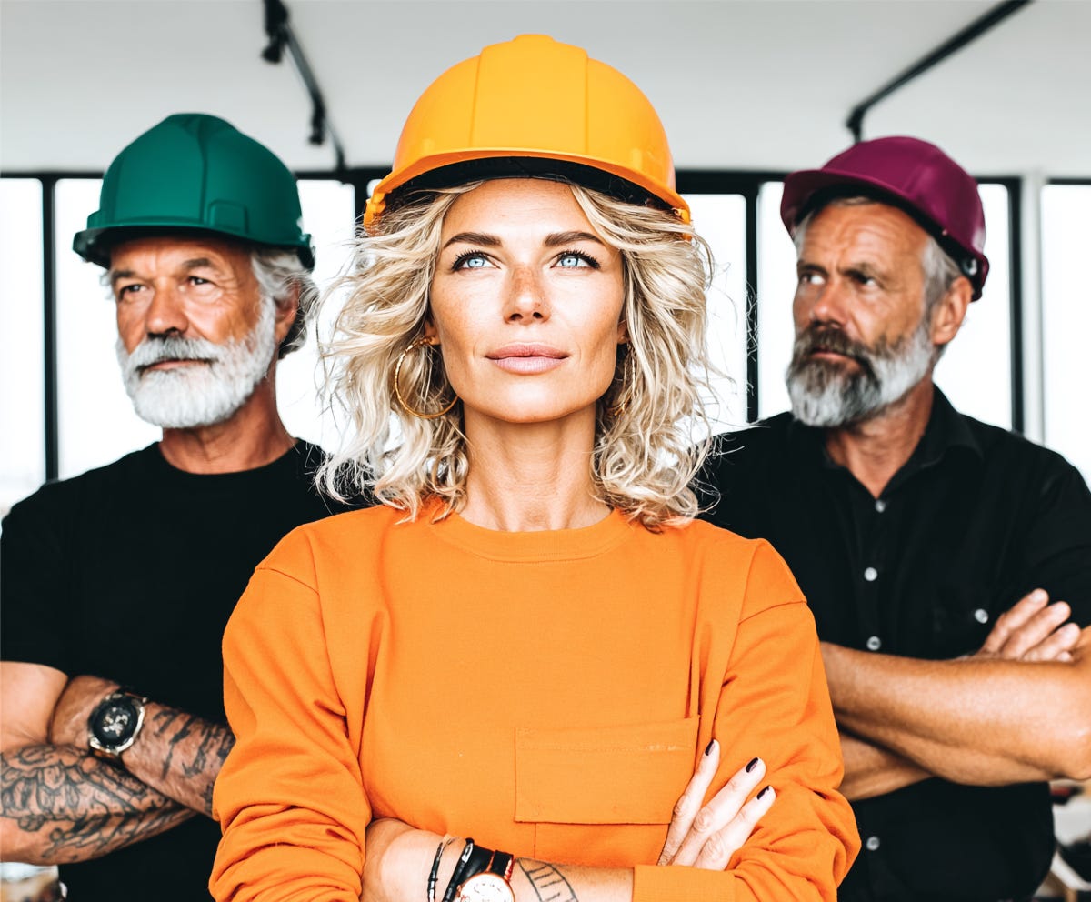 an interior designer in an orange shirt stands in front of two builders, taking charge, supporting the builders behind her, plush design interiors adelaide