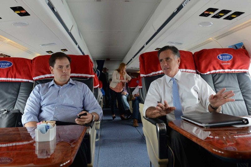 Former Republican Presidential candidate Mitt Romney speaks with Senator Marco Rubio while flying from Pensacola to Orlando, Florida, on October 27, 2012. Former Republican Presidential candidate Mitt Romney speaks with Senator Marco Rubio while flying from Pensacola to Orlando, Florida, on October 27, 2012.