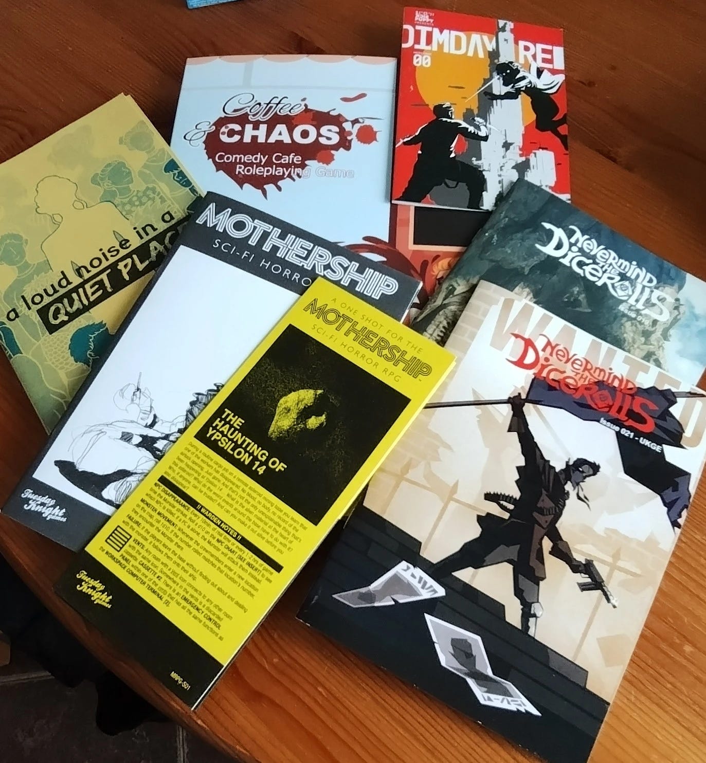 A collection of small press RPGs including Never mind the dice rolls, coffee and chaos, a loud noise in a quiet place, mothership and dimday red