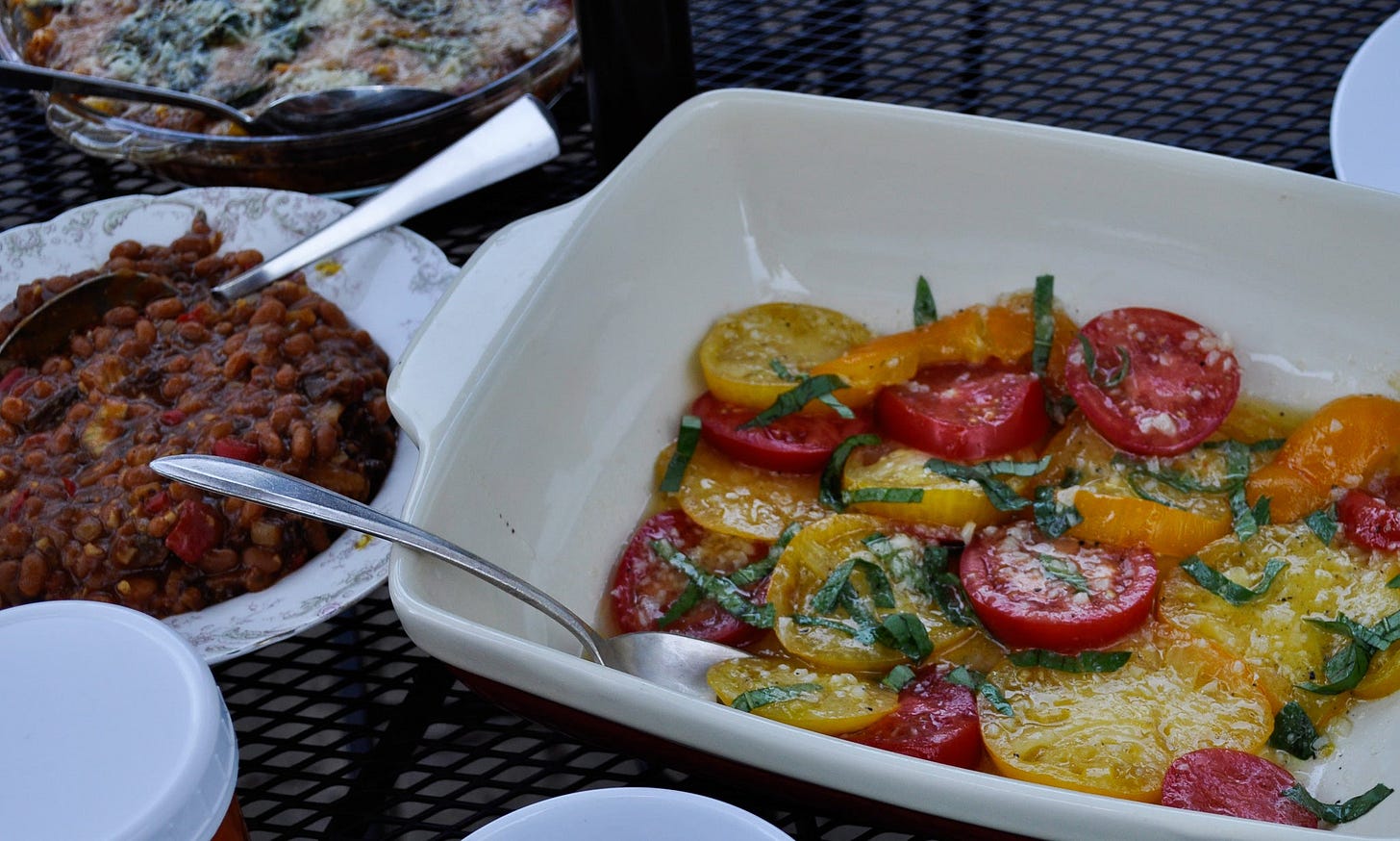 tomato salad and baled beans on a table