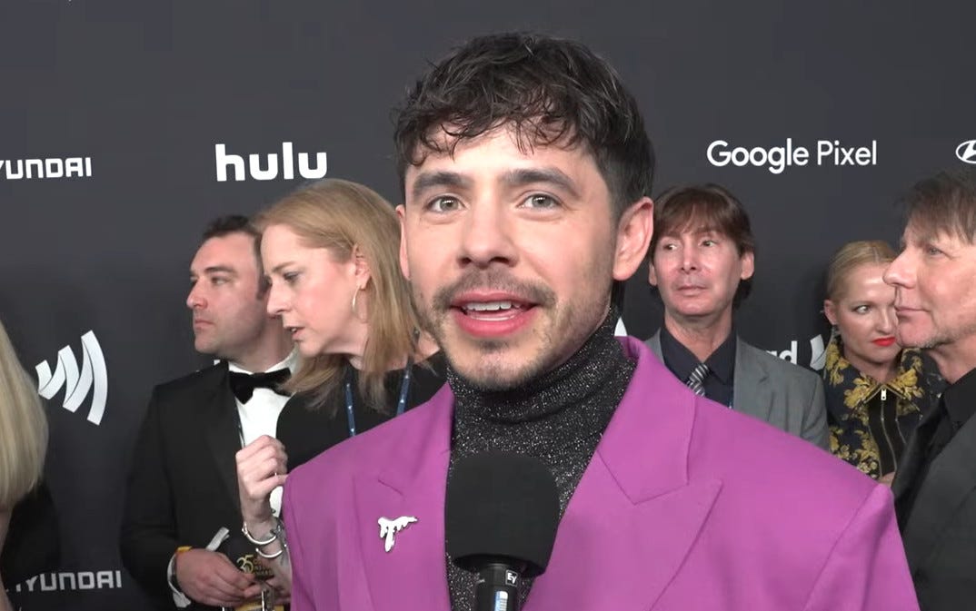 David Archuleta with a microphone in front of him and several people in the background David Archuleta with a microphone in front of him and several people in the background