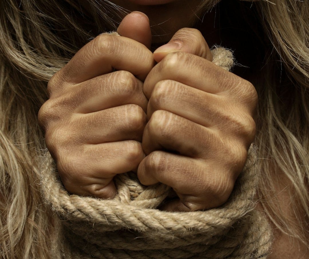 woman with hands tied