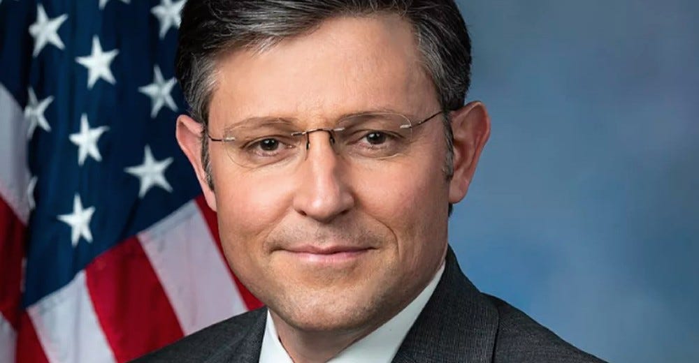 House Speaker Mike Johnson posing for his official photo in front of an American flag. 