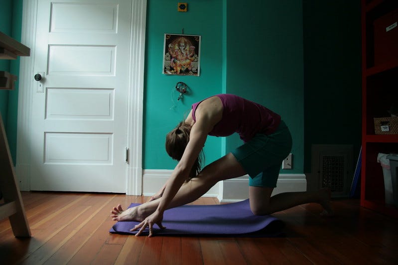 kelly in ardha hanumanasana, bent over one leg