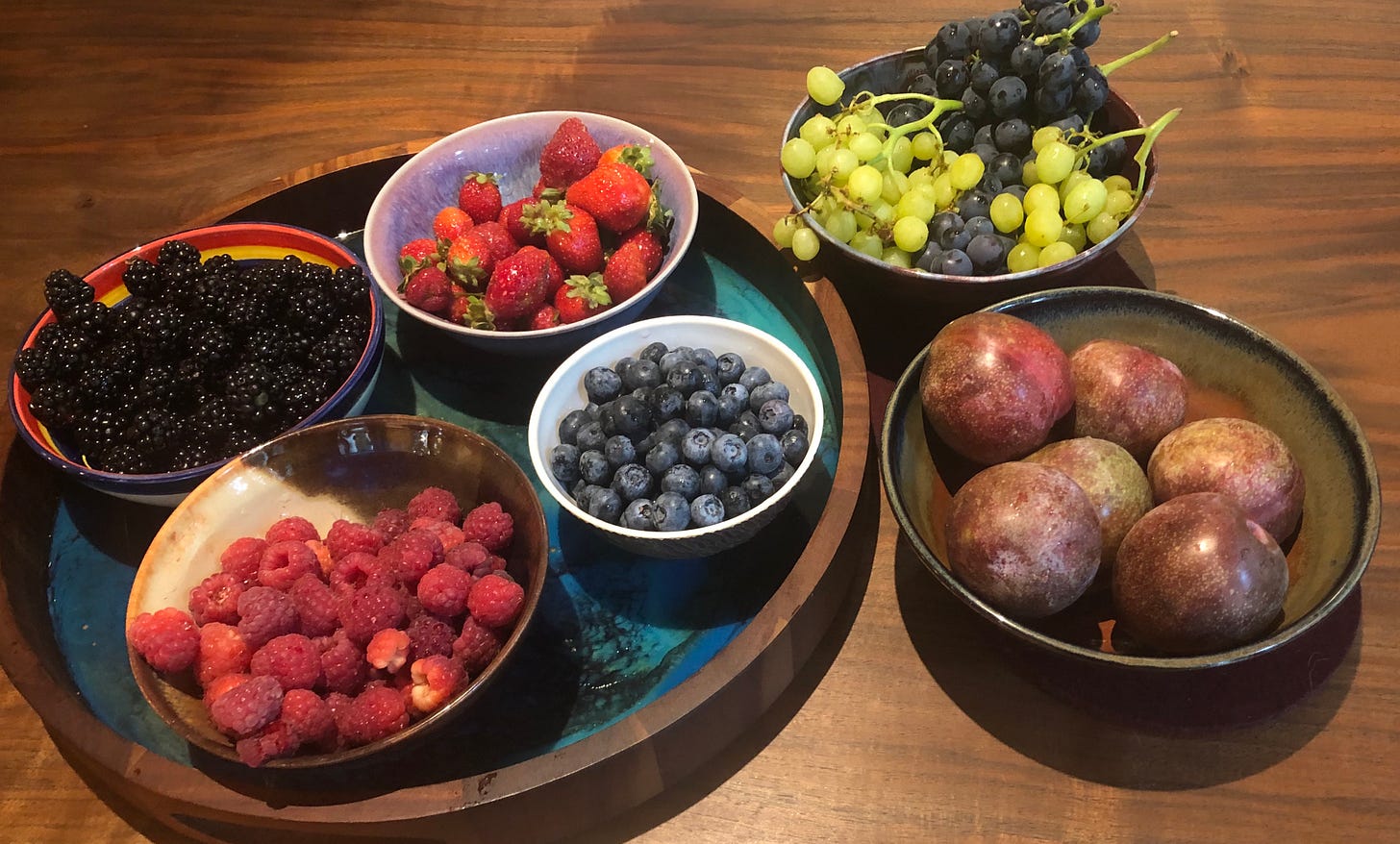 Blackberries, strawberries, raspberries, blueberries, plums, and two kinds of grapes, all from a single farmer's market in early September, 2021