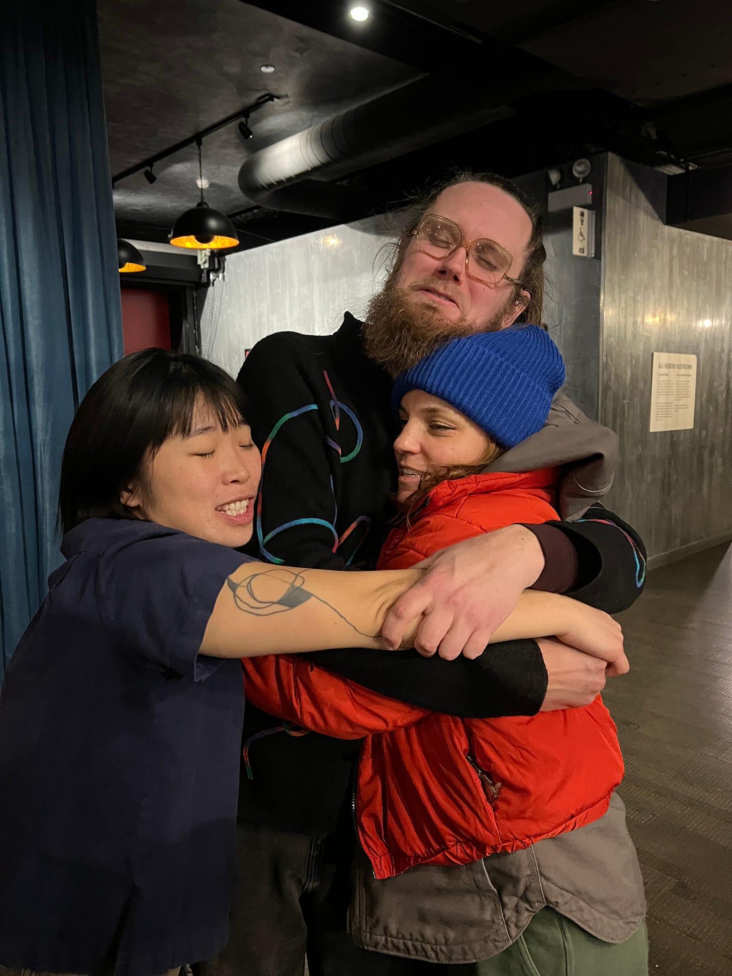 Corey, Kara, and Erin in a sad embrace.