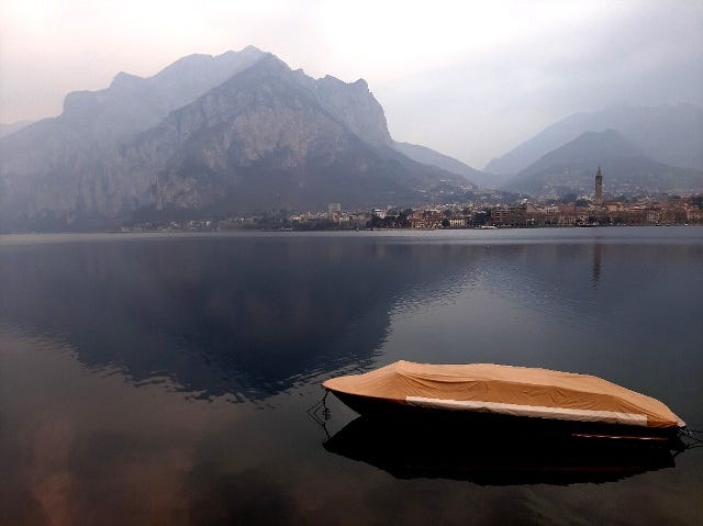 a solitary boat on the lake on Lecco's side