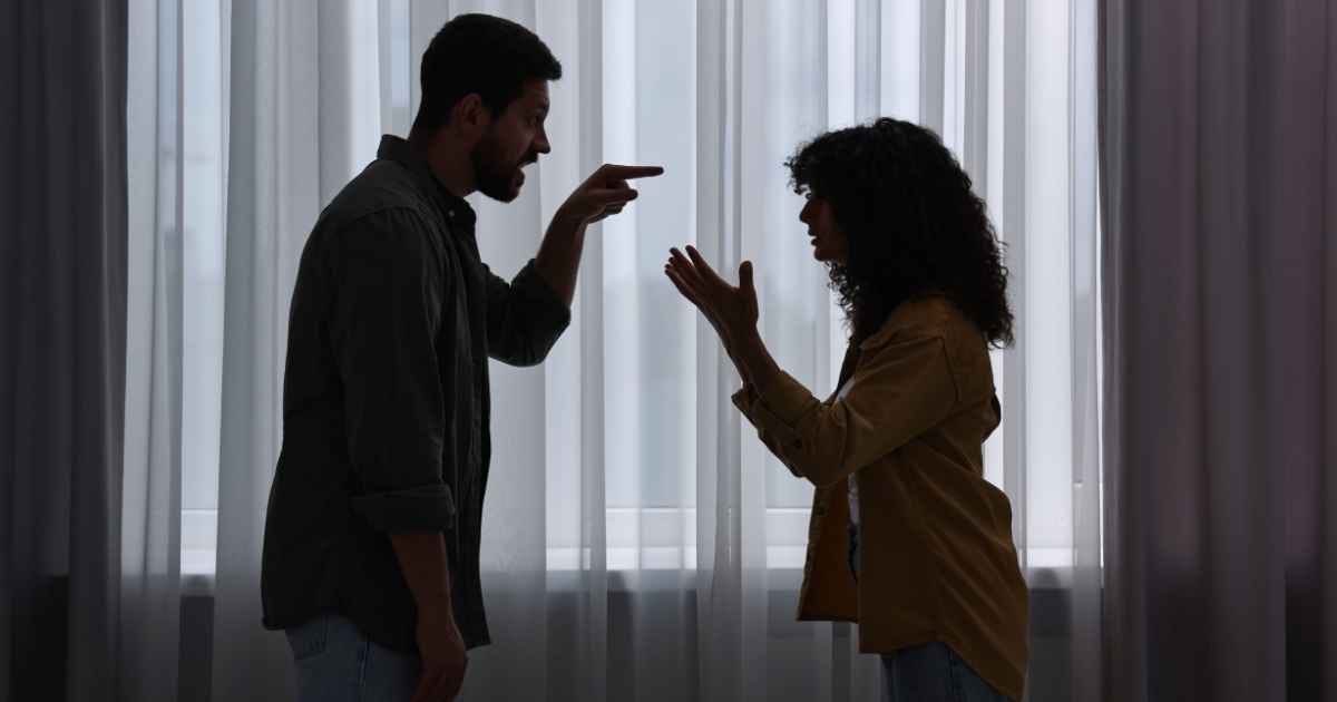 Emotional couple arguing indoors at night. Relationship problems Emotional couple arguing indoors at night. Relationship problems