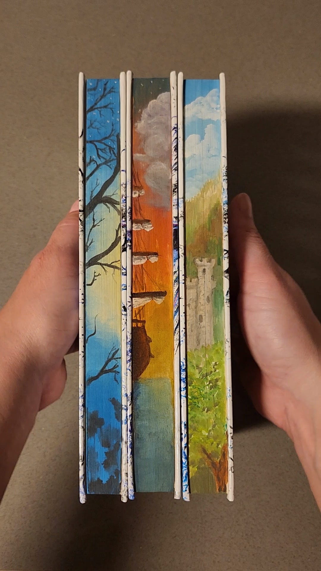 hand-painted edges of The Chronicles of the Twelve Realms hardbacks by Rachael Ritchey