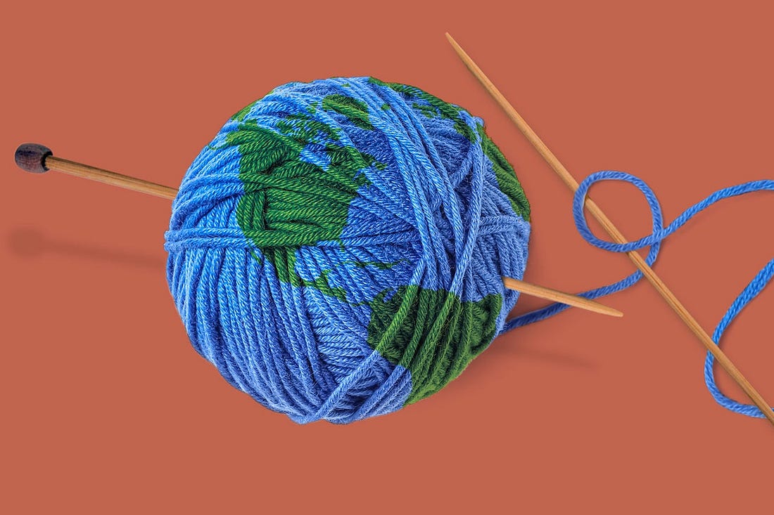 Knitting needles and ball of blue yarn with earth overlaid. 