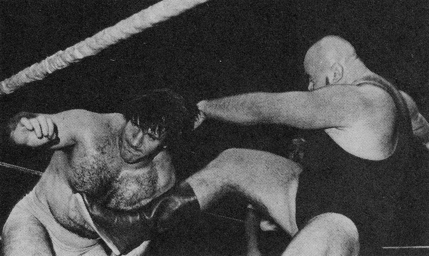 Bruno Sammartino, with dark hair, recoils in the corner as a bald Ivan Koloff, in a dark singlet, throws a punch, at Madison Square Garden in 1975
