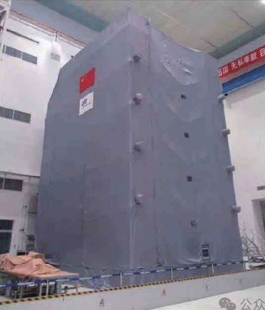 An assembled Long March 2F/G in (left) and a Shenzhou spacecaft under a protective cover (right) at the Jiuquan Satellite Launch Center.